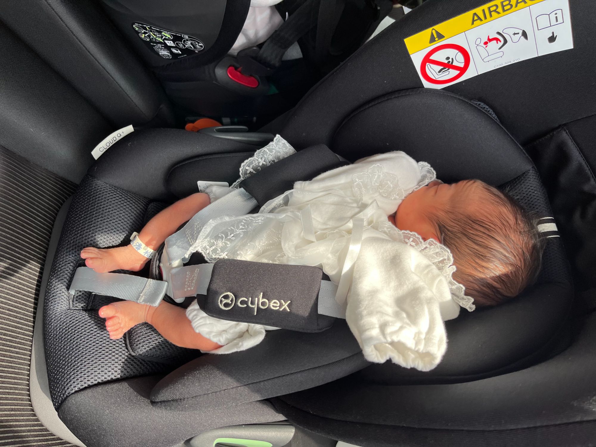 車内でぐっすり眠る新生児